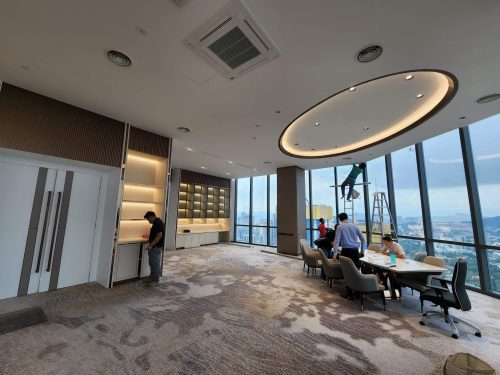 a room with a large window and a group of people