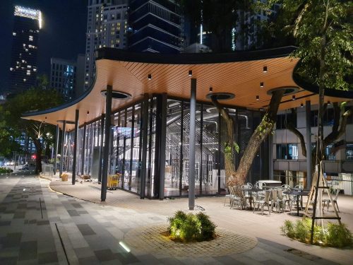 a building with a curved roof and glass walls